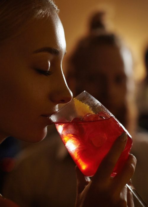 close-up-profile-of-glamorous-blonde-girl-enjoying-fresh-fruit-drink-sitting-at-bar-counter-next-to.jpg